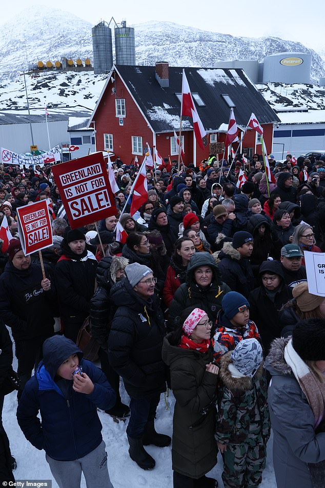 Protesters in Nuuk, Greenland hold Greenlandic flags and 'Greenland Is Not For Sale' placards outside the U.S. consulate.