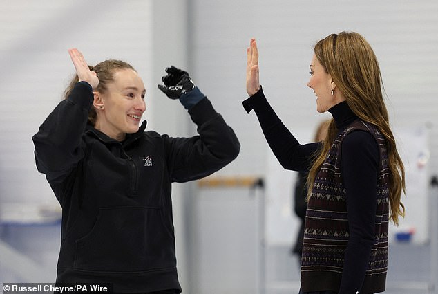 Onlookers, including Prince William, cheered Kate on as she high-fived Scottish curler Jen Dodds