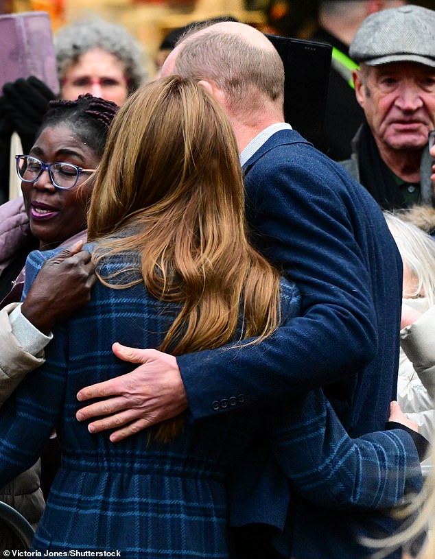 William placed a loving arm around his wife's upper back as they posed for photographs with the public