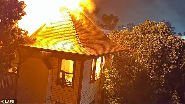 About 70 Los Angeles firefighters work to knock down the motel blaze