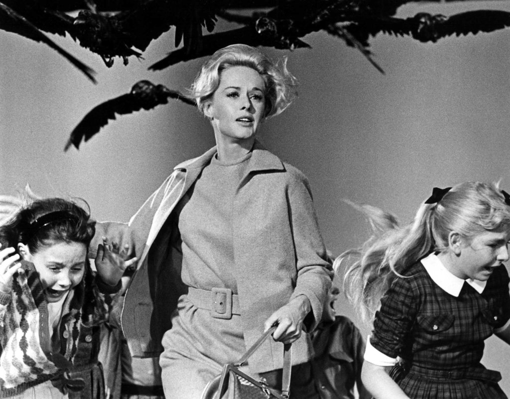 Tippi Hedren, central, with two children, fleeing from a bird attack in the film "The Birds".