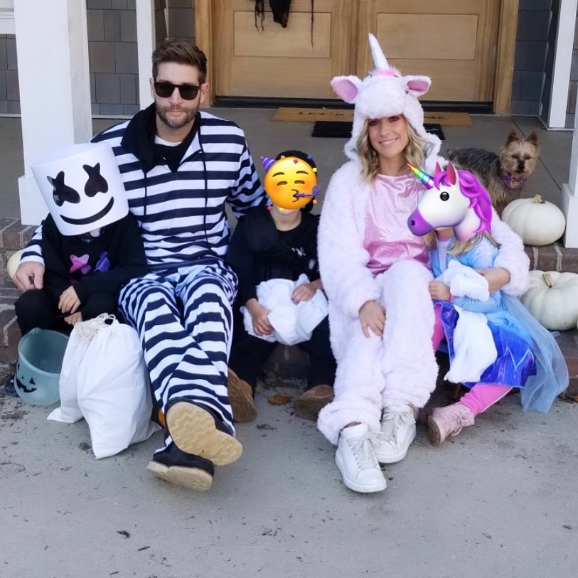 Kristin Cavallari and Jay Cutler in Halloween costumes with their three children and a dog on their porch.