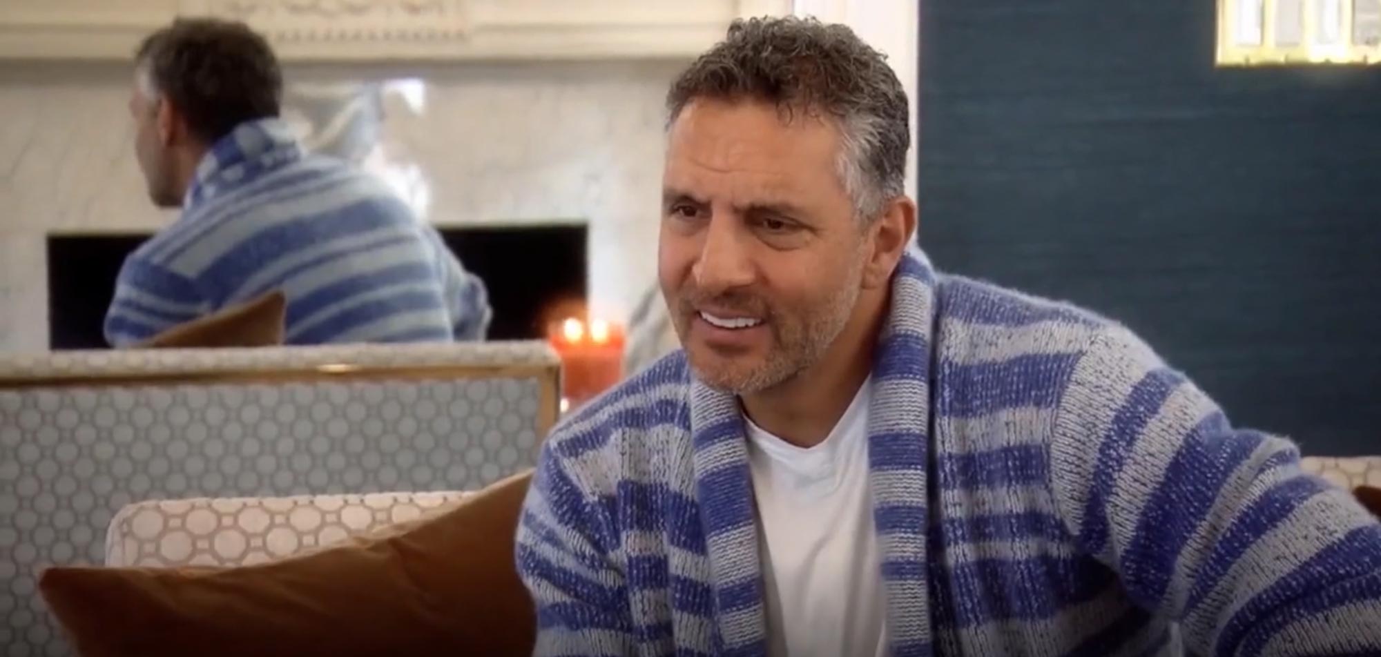 Mauricio Umansky appears on a Bravo show, seated on a couch.