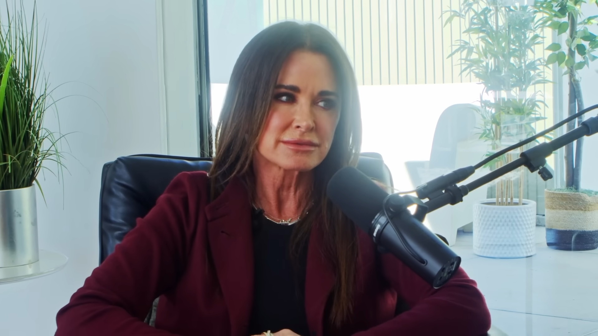 Kyle Richards speaking into a microphone.