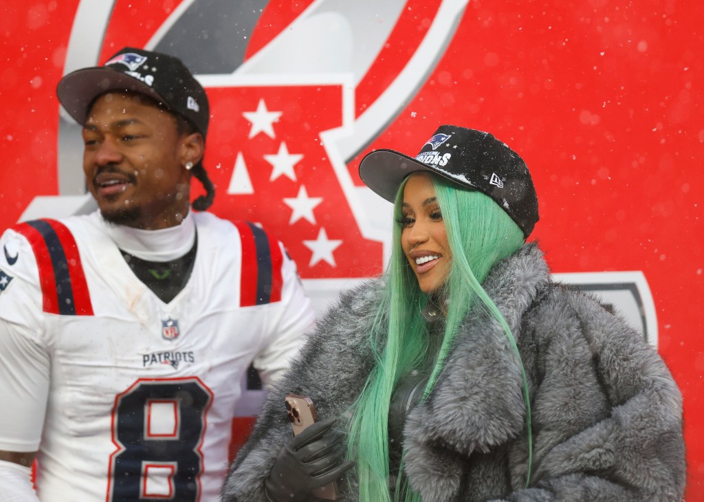 Stefon Diggs and Cardi B share a celebratory moment on the field after the AFC Championship win.