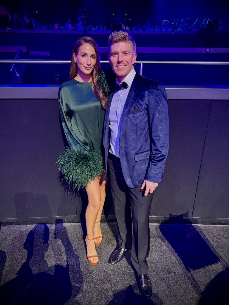 Amanda Batula and Kyle Cooke standing and smiling at an event.