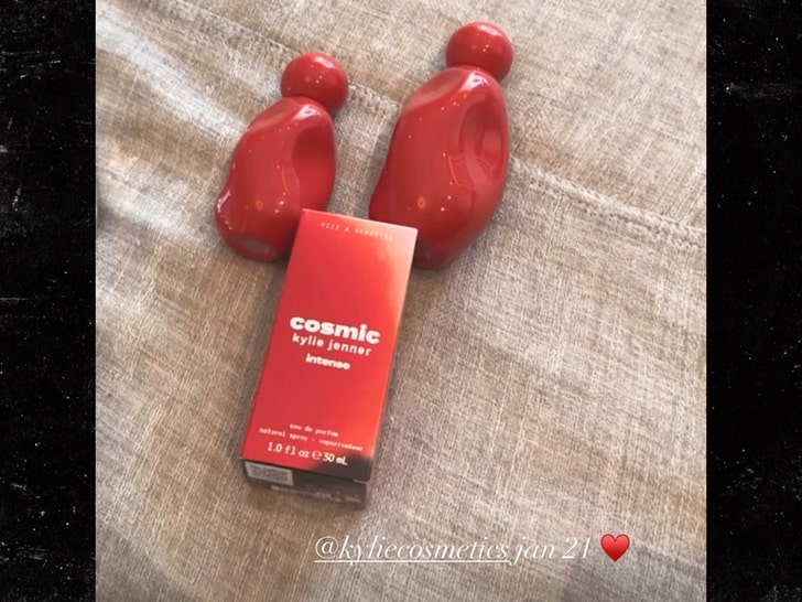 Kylie Jenner in a sculpted red leather look holding the crimson Cosmic Intense perfume bottle - Instagram/@kyliejenner campaign image