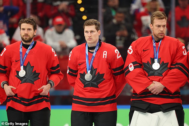Nathan MacKinnon looks dejected after Canada's overtime loss to USA in the Olympic gold medal game