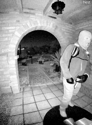 Security camera still showing a masked figure on Nancy Guthrie's doorstep in the early hours of February 1