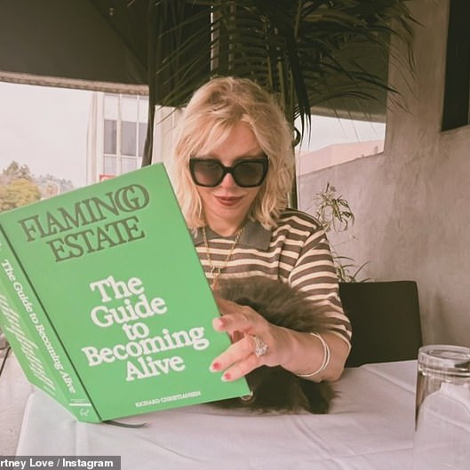 Courtney Love posted a picture of herself reading 'the guide to becoming alive' as new report claims her late husband Kurt Cobain's death was a 'homicide' - DailyMailUS