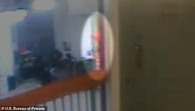 CCTV still showing a shadowy orange shape moving up the stairs toward Epstein's cell block