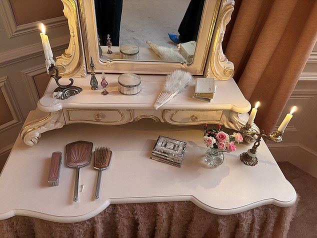 Cathy's sprawling bedroom decorated in opulent pink and gold inside the Wuthering Heights-inspired suite