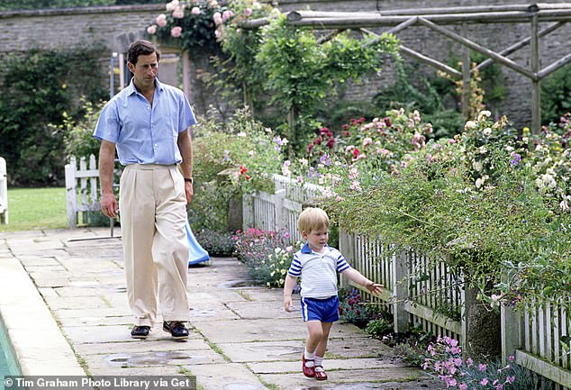 King Charles with a young Prince Harry in the gardens at Highgrove