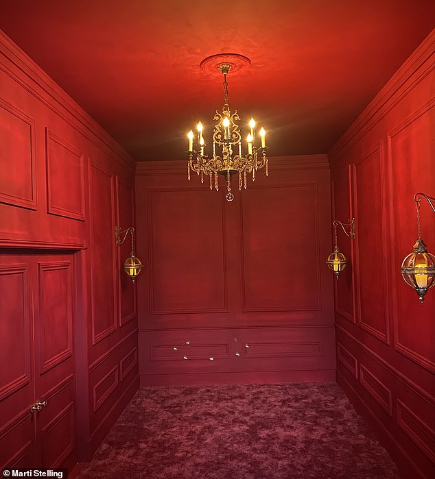 Entrance to the suite through an unassuming stone outbuilding leading to a candle-lit red velvet hallway