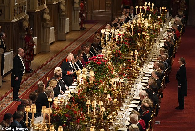 King Charles raises a toast at a formal banquet