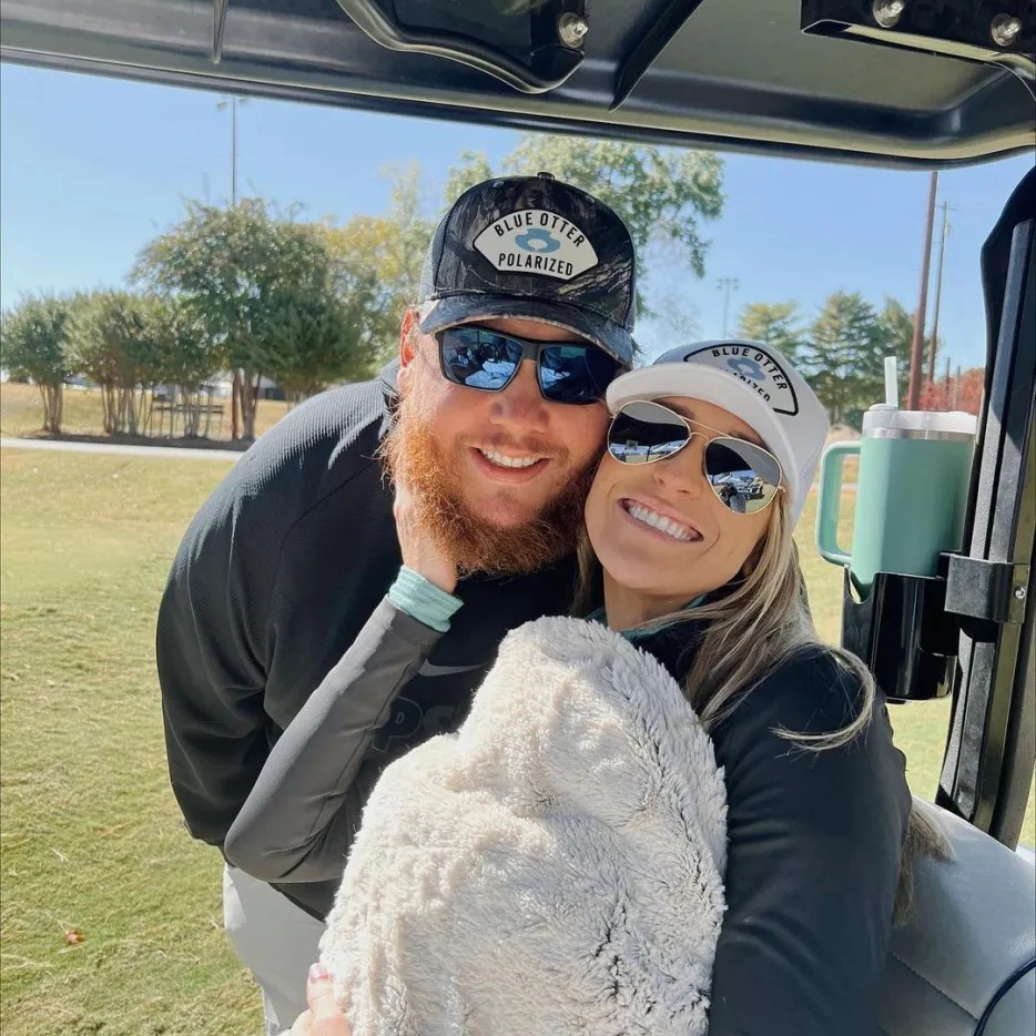 Luke Combs and Nicole Hocking smiling in a golf cart. - nicolejcombs/Instagram