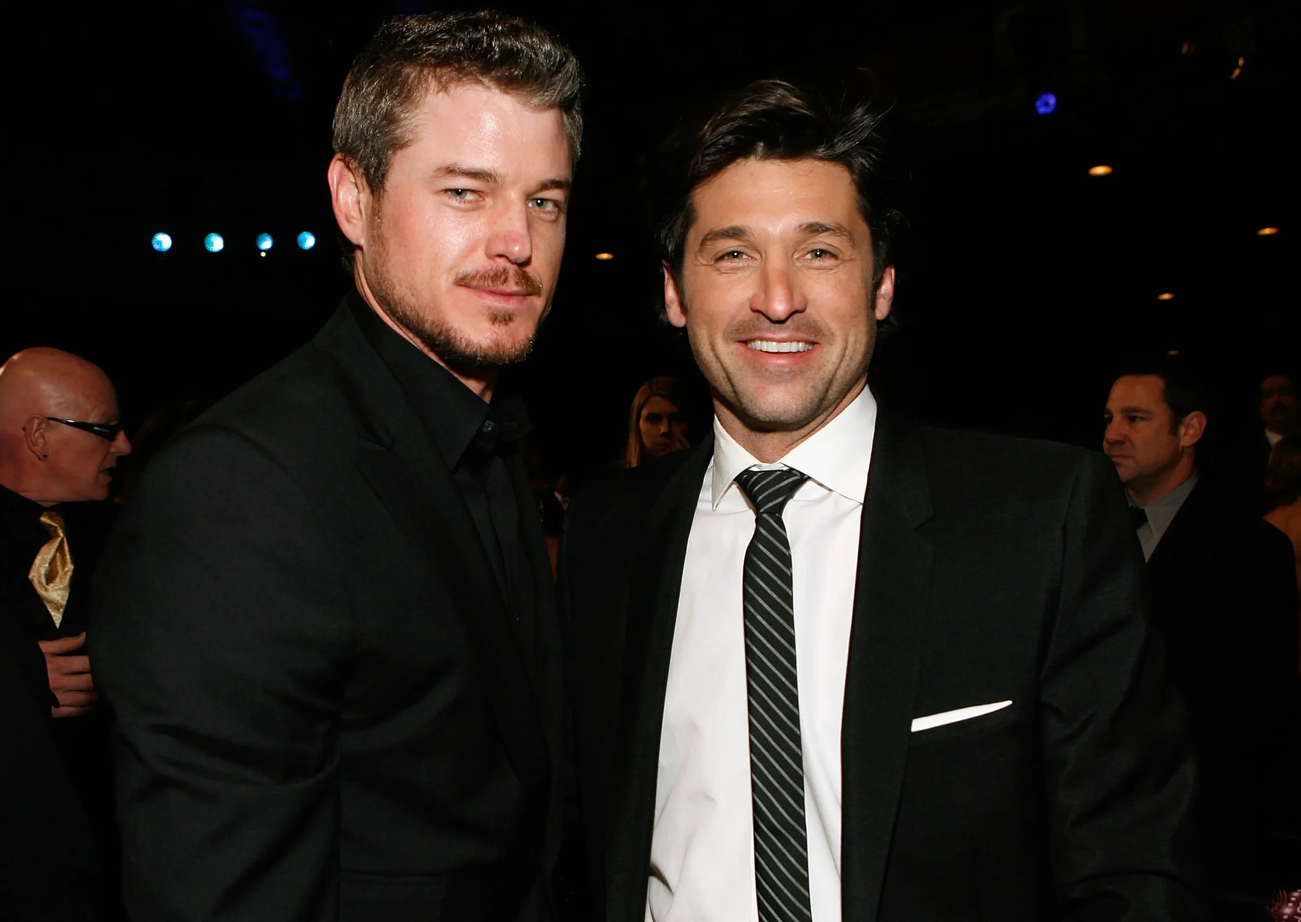 Actors Eric Dane and Patrick Dempsey pose in the audience at an awards show.