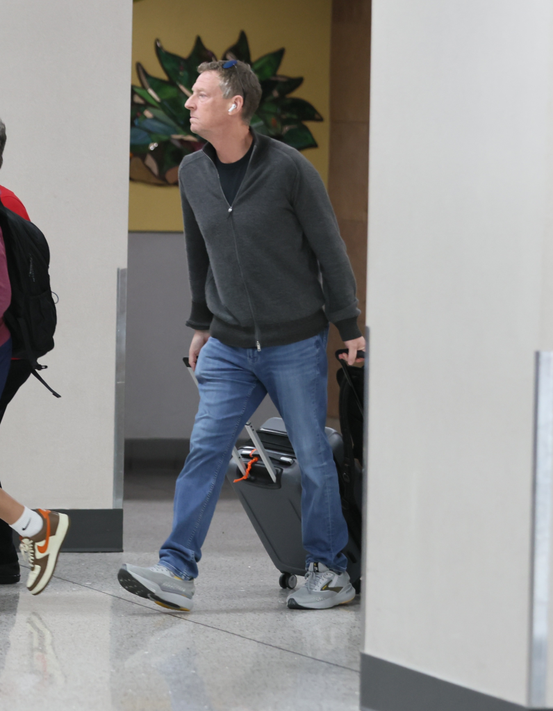 Michael Feldman arrives at Tucson International Airport, pulling luggage, as he joins Savannah Guthrie amid the search for Nancy Guthrie.