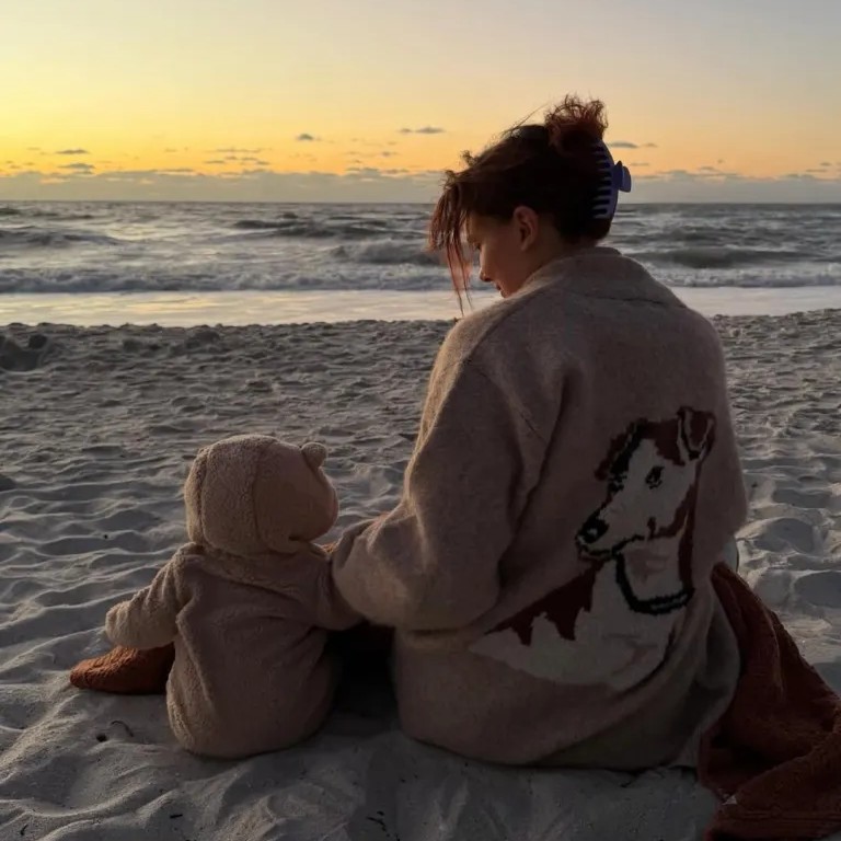 Millie Bobby Brown posted a rare photo on Instagram Friday of her and her daughter sitting on the beach to celebrate her 22nd birthday. - Instagram/milliebobbybrown