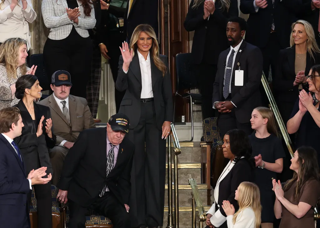 Melania Trump stands and waves from the first lady's box during the State of the Union.