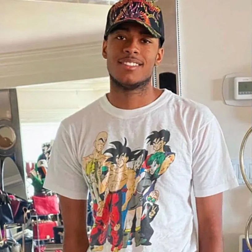 Robert Cosby Jr. smiling and wearing a Dragon Ball Z t-shirt and baseball cap. - Bravo
