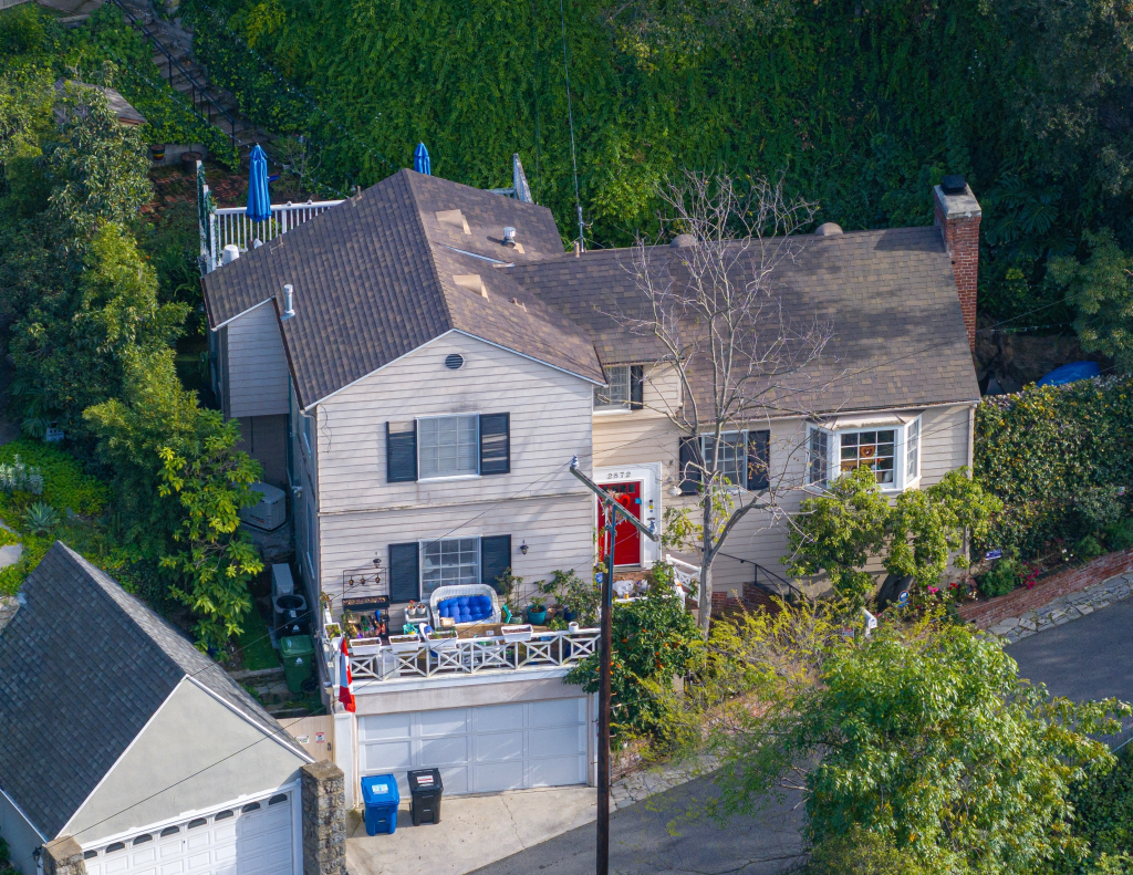 An aerial view of Katherine Short's home, with a red front door, a white garage, and a balcony.