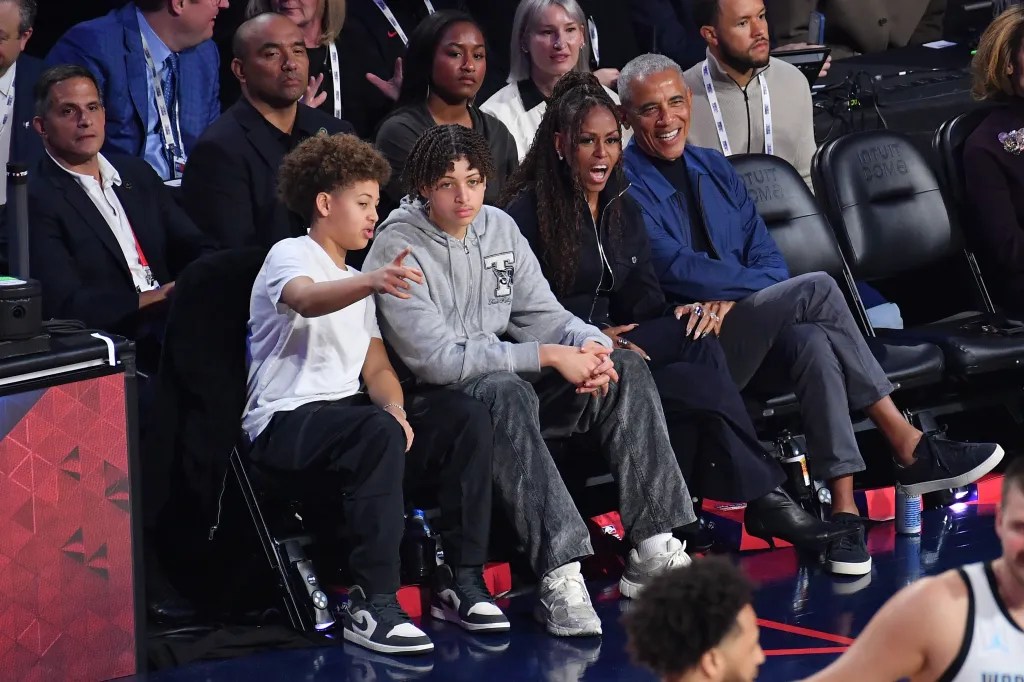 Barack and Michelle Obama seated courtside at the Intuit Dome during NBA All-Star Weekend.