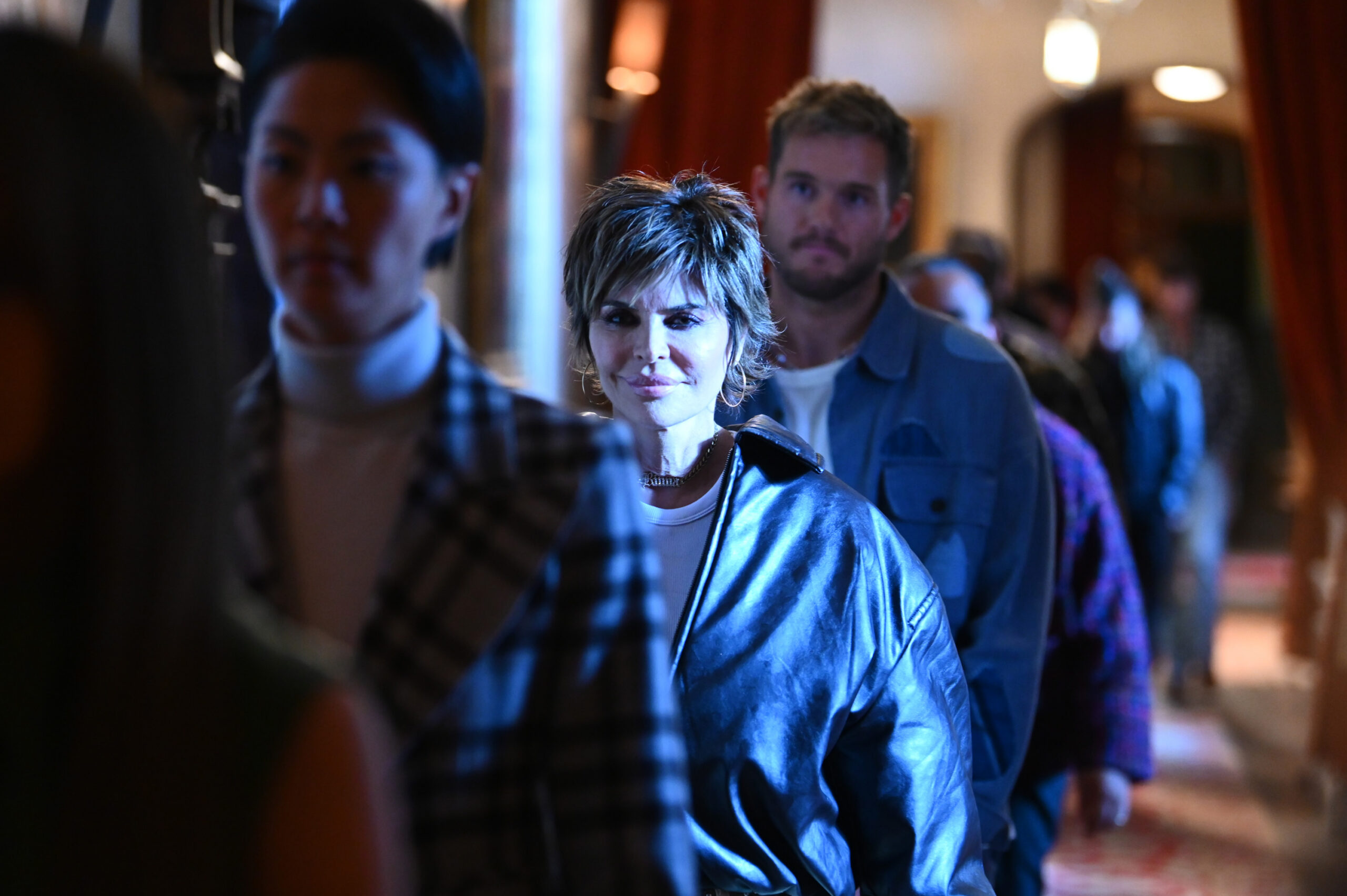 Kristen Kish stands with Lisa Rinna and Colton Underwood during a lineup on The Traitors.