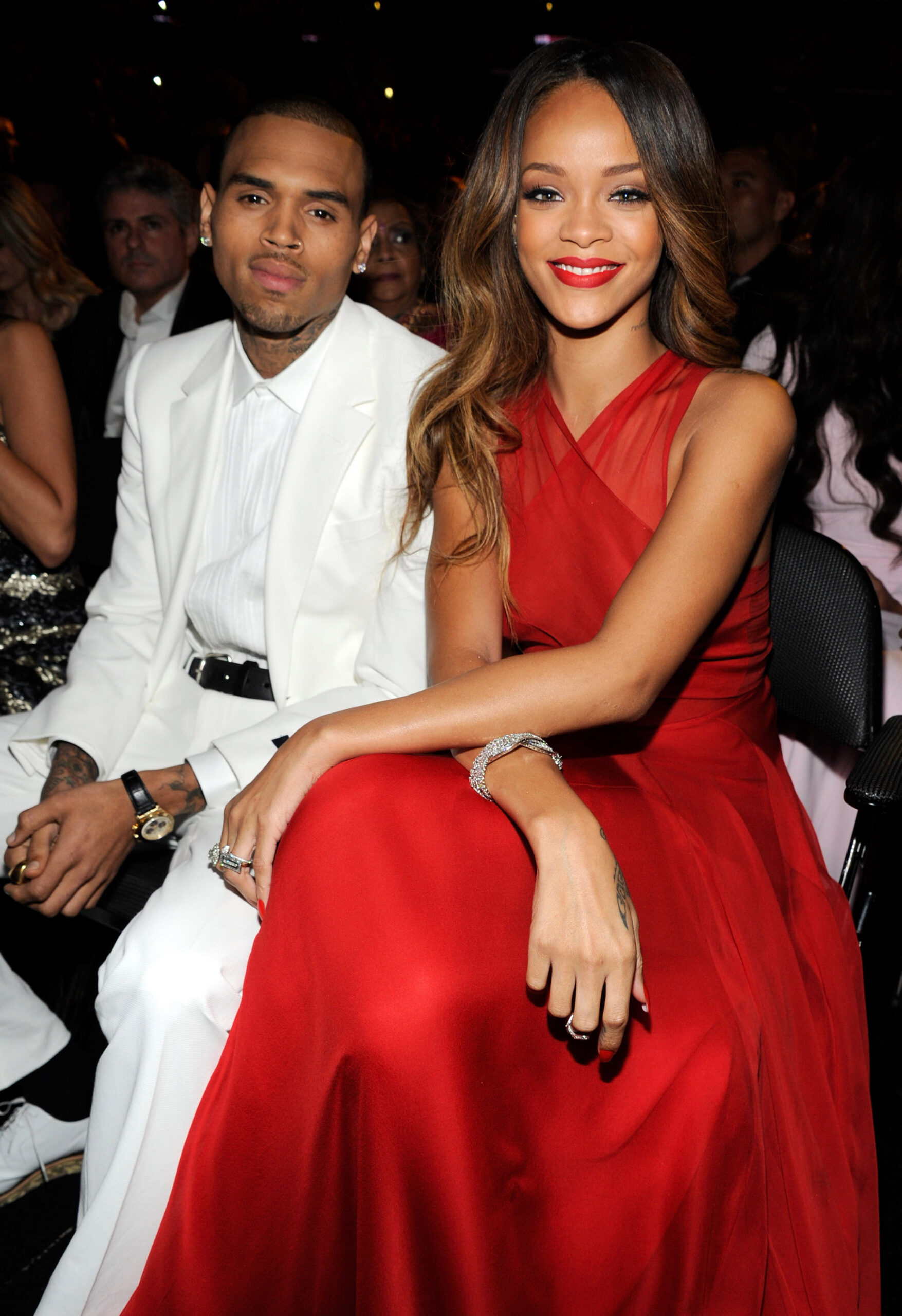 Chris Brown and Rihanna seated together at an event.