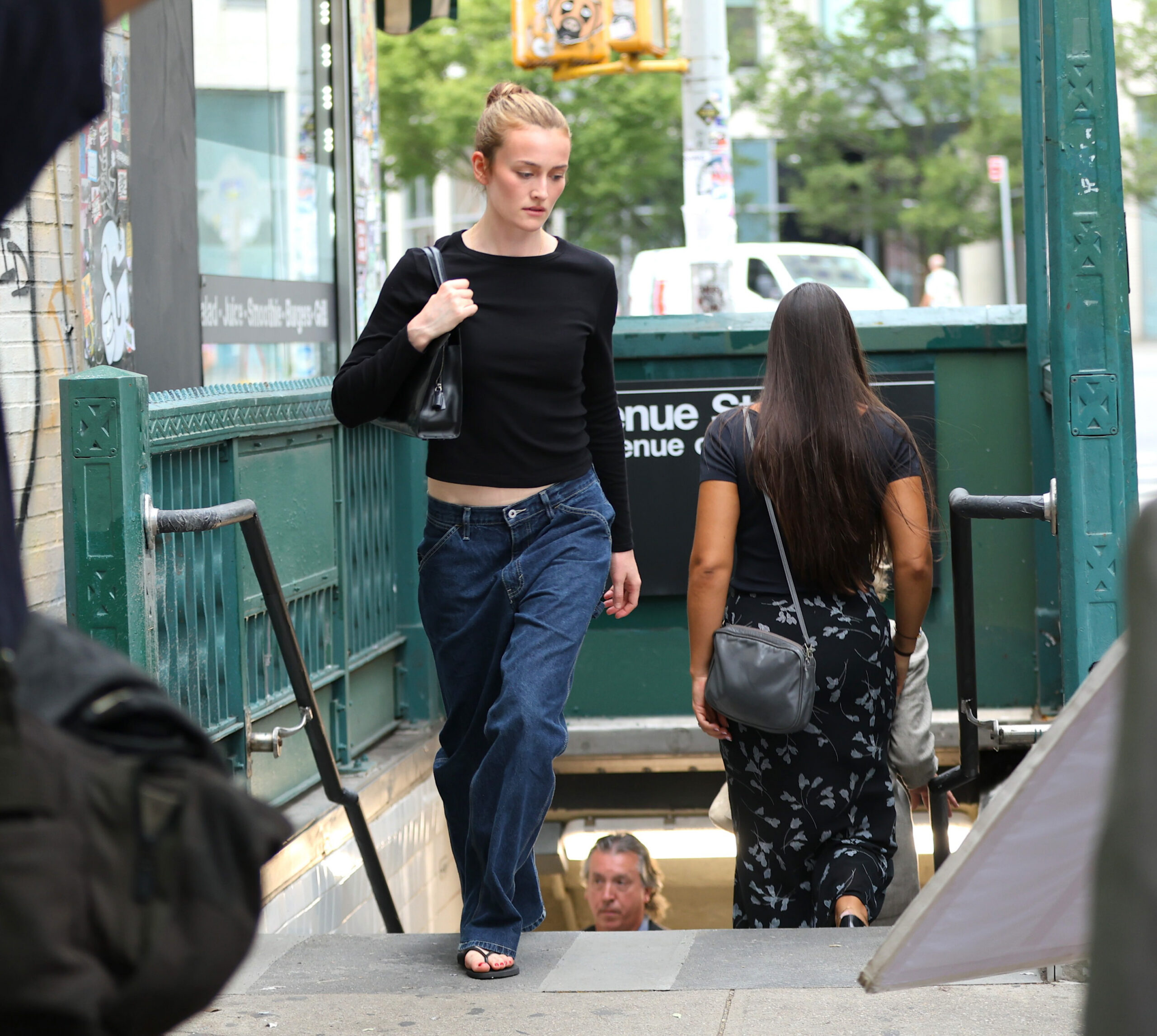 Sarah Pidgeon as Carolyn Bessette emerging from a New York City subway in American Love Story.