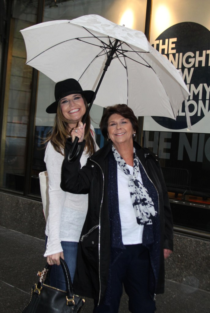 Savannah Guthrie and her mom pose under an umbrella.