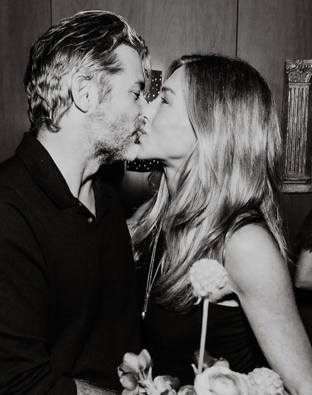 Black-and-white photo of Jennifer Aniston and Jim Curtis kissing, from his Instagram birthday tribute.