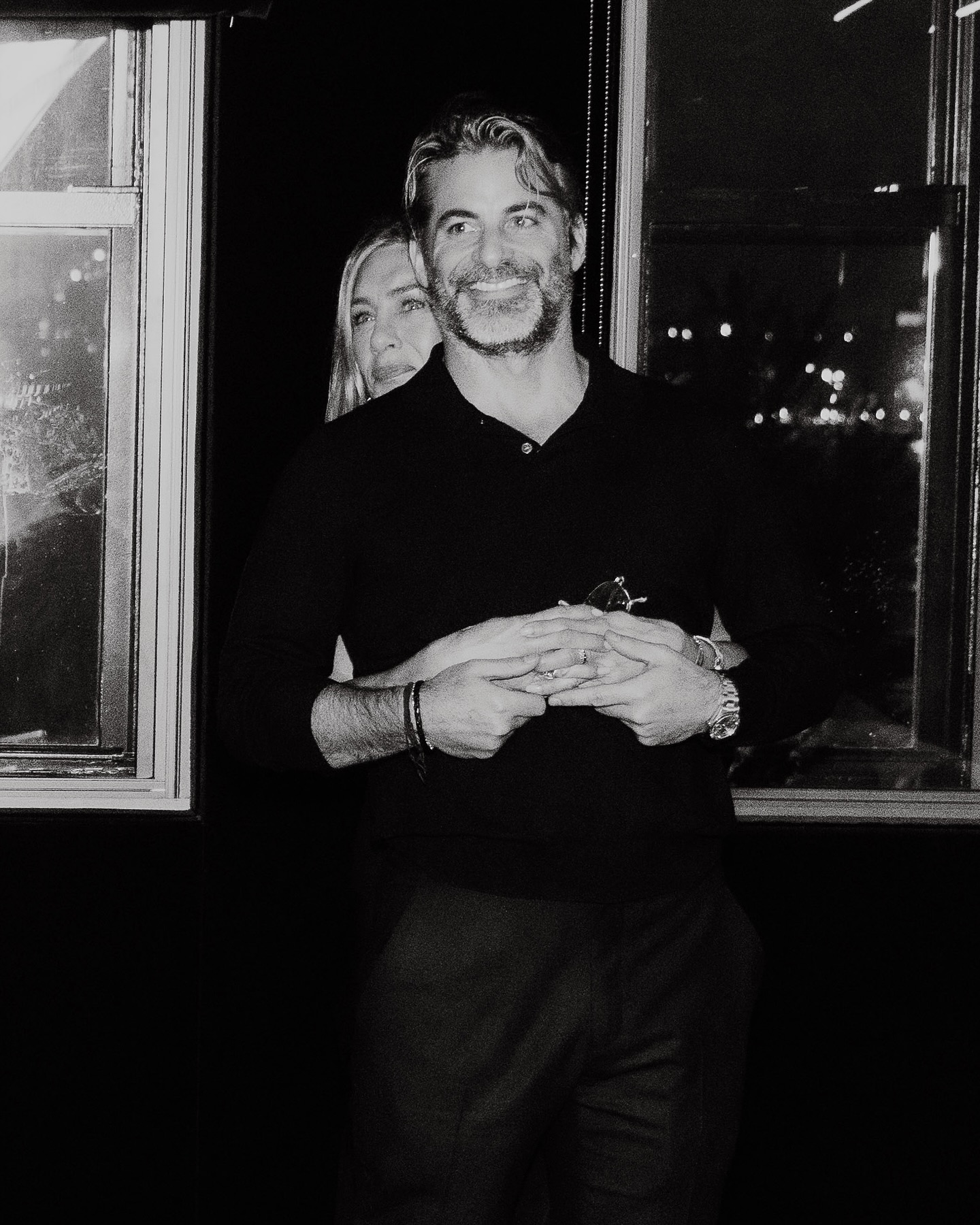 Jennifer Aniston hugging Jim Curtis from behind in a black-and-white birthday post.