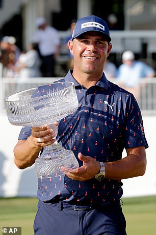 Gary Woodland holds the Houston Open trophy after a five-shot victory that secured his Masters invite