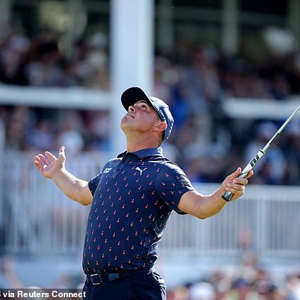 As his putt dropped on the 18th hole, Woodland spread his arms wide and looked to the skies - Daily Mail US