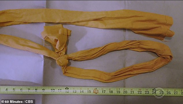 One of the improvised bedsheet nooses recovered from Epstein's cell, photographed with a measuring tape
