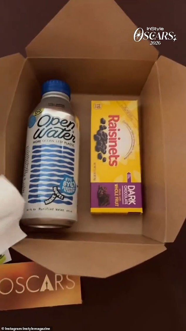 The 2026 Oscars snack box with SkinnyPop popcorn, dark chocolate Raisinets, and bottled water inside the Dolby Theatre.