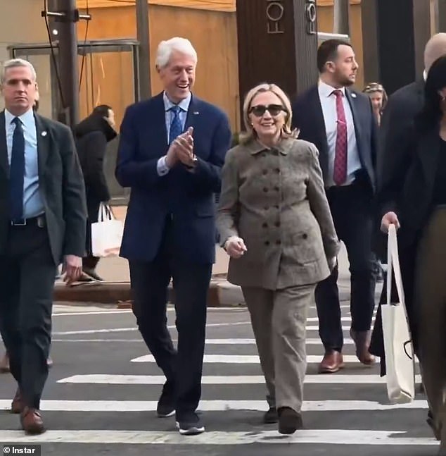 The couple seemed to be in a joyous mood, with the 79-year-old former president clapping his hands as they crossed while his wife smiled - Daily Mail US