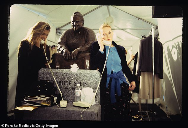 Carolyn Bessette backstage with a model at Calvin Klein's 1994 ready-to-wear show in Bryant Park.