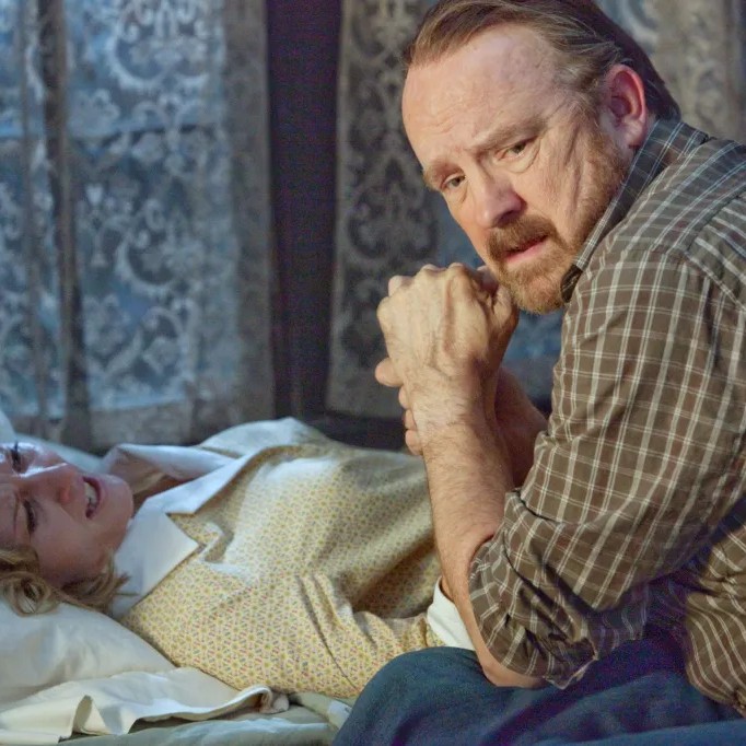 Jim Beaver kneels by Carrie Anne Fleming who is lying upset on a bed. - Page Six