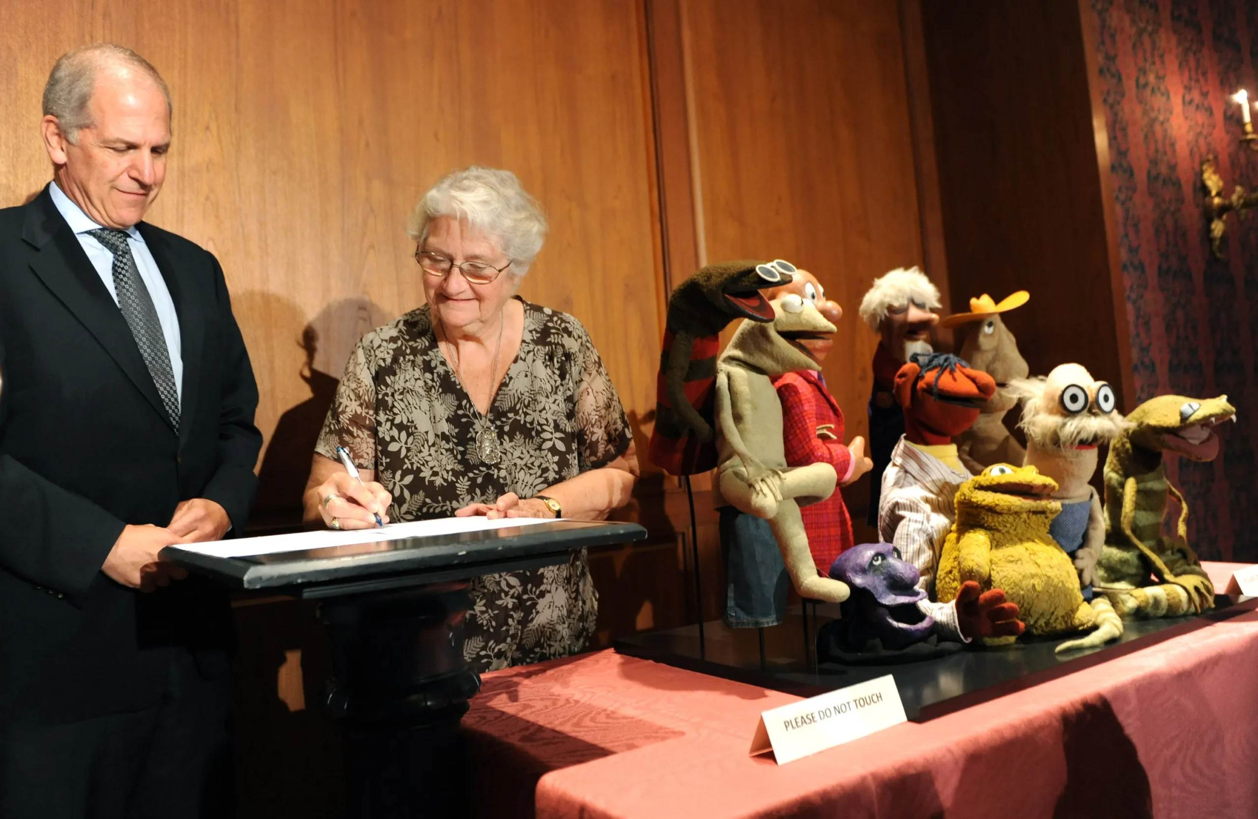 Jane Henson signs donation documents for Sam and Friends puppets, including the original Kermit the Frog, at the Smithsonian's National Museum of American History in 2010.