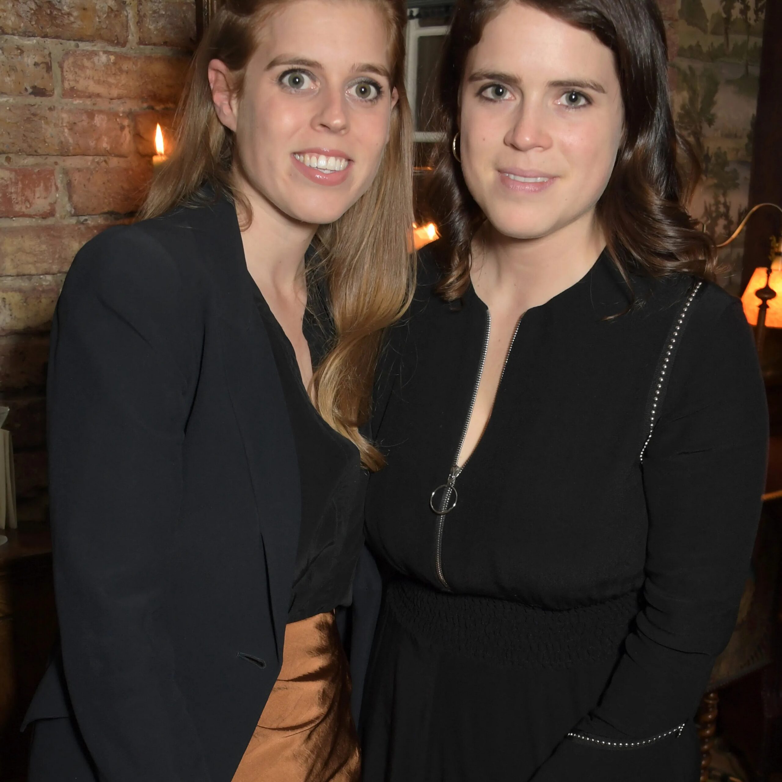 Princesses Beatrice and Eugenie, seen here at a London event in November 2021, are said to be "horrified" by the fallout from their father's involvement in the Jeffrey Epstein scandal. - Dave Benett/Getty Images for Loci