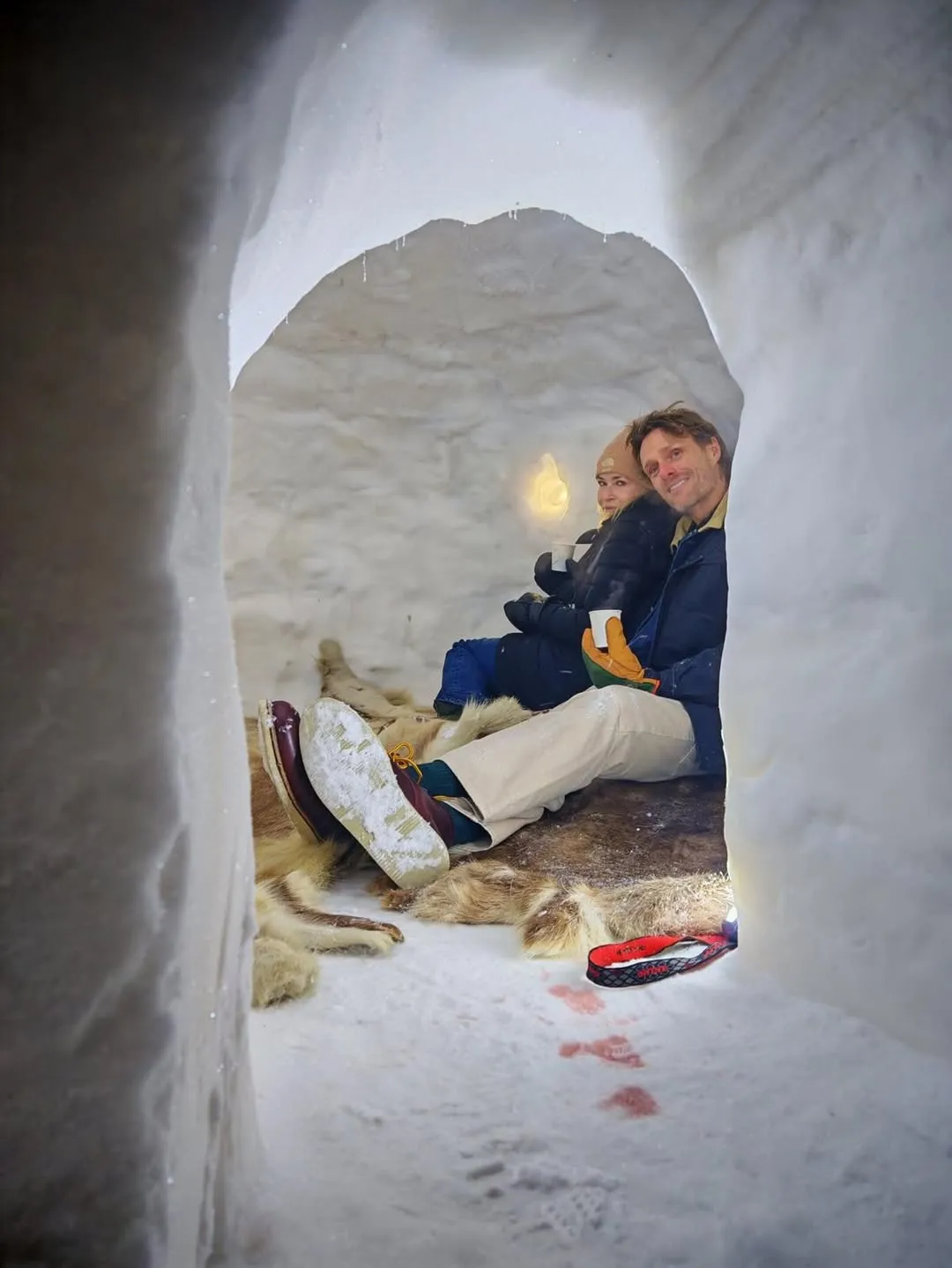 Chelsea Handler and an unidentified man snuggle inside an igloo in Finland.