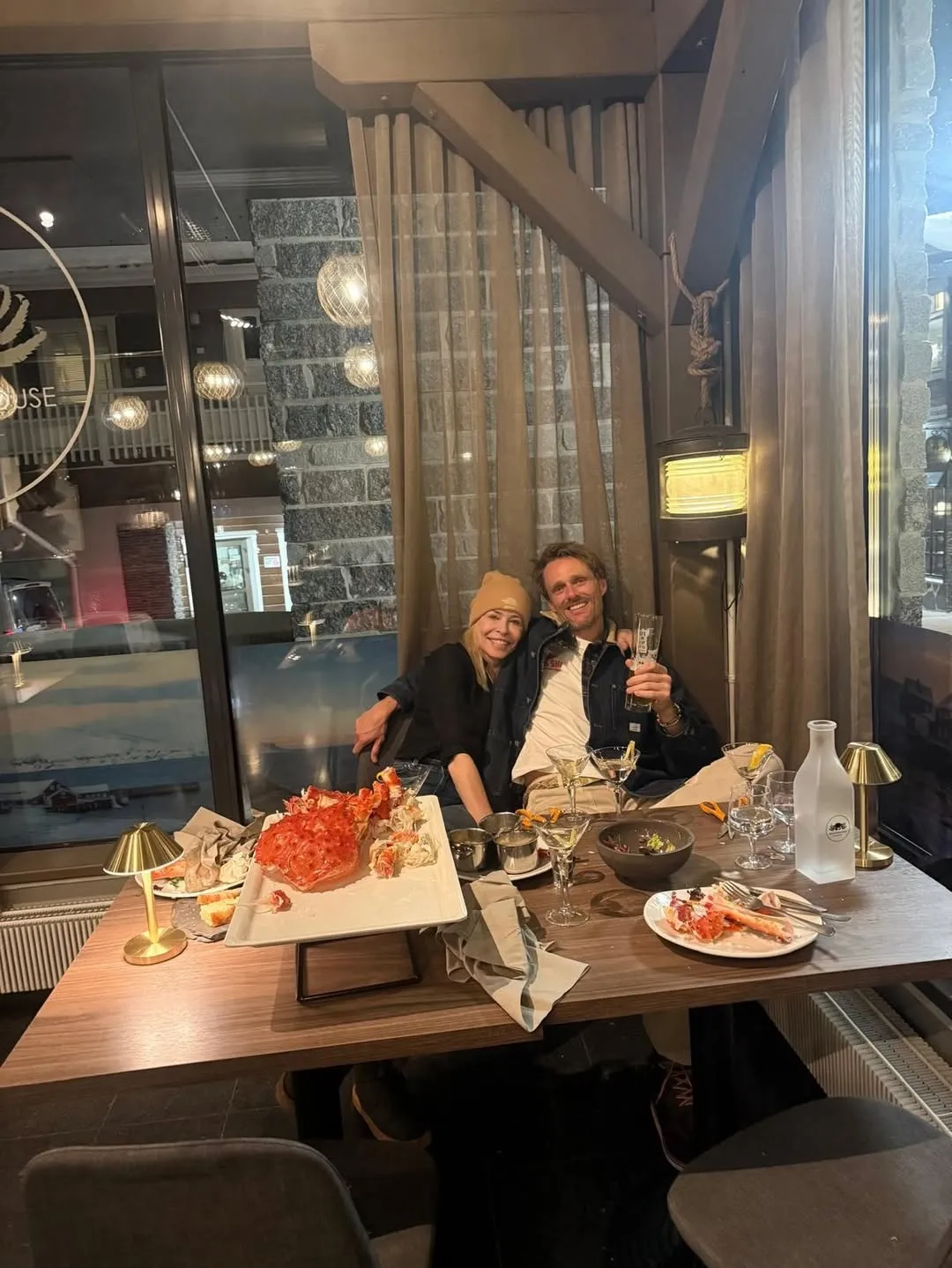 Chelsea Handler and ex-boyfriend Jo Koy at a restaurant with a platter of king crab.