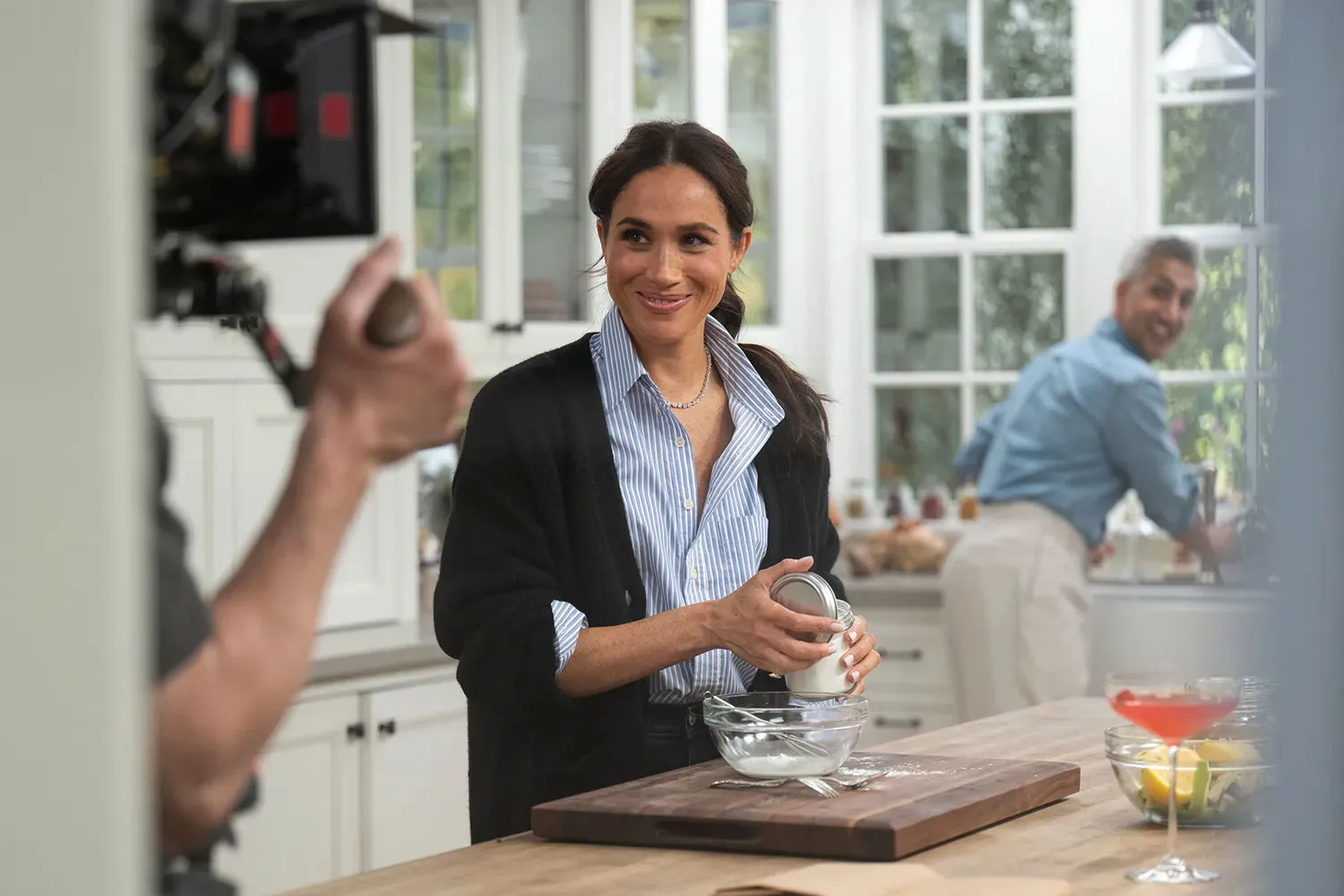 Meghan Markle filming With Love, Meghan in a kitchen with Tan France.