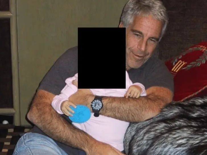 Jeffrey Epstein holding a baby; child's face redacted in DOJ evidence photo