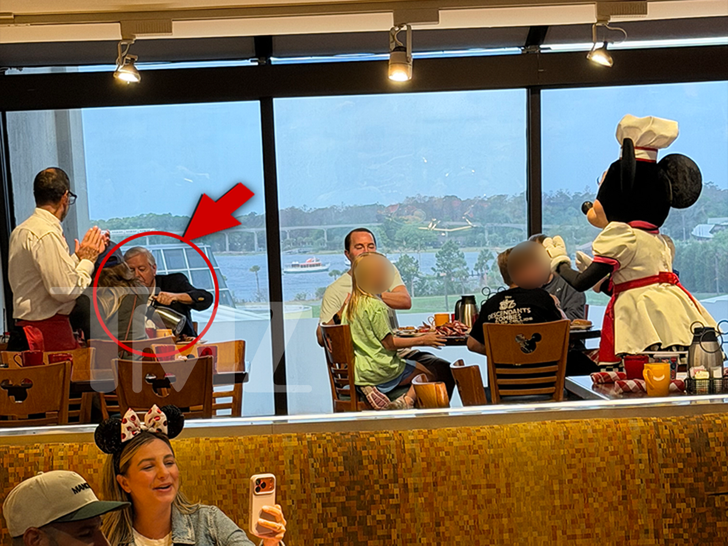 Wide restaurant shot from TMZ highlighting Sen. Lindsey Graham at a back table during a character breakfast at Disney World.