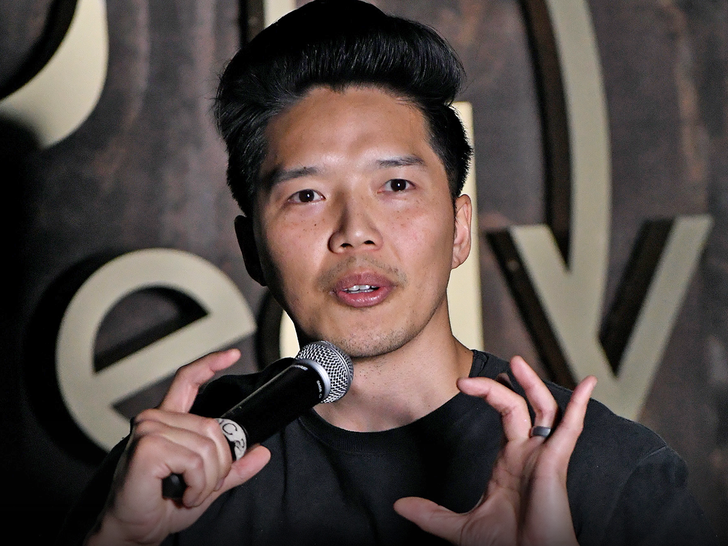 Portrait of comedian Alex Duong holding a microphone.