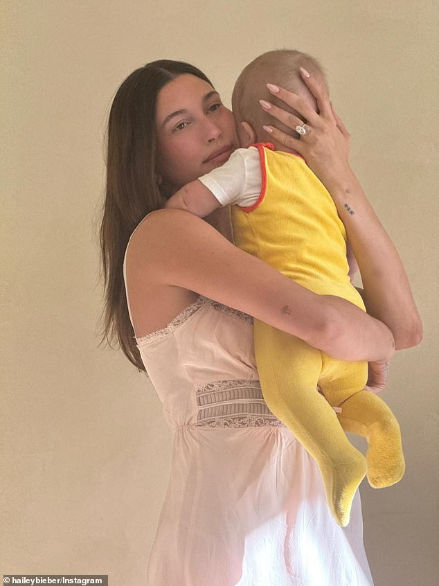 Hailey Bieber in the crowd holding baby Jack during Justin's set.