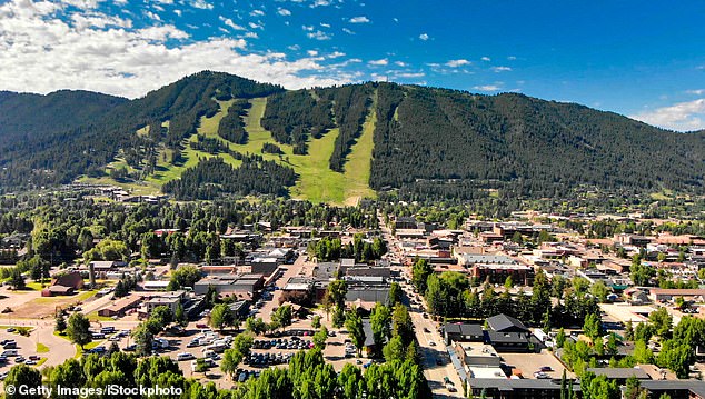 A panoramic aerial view of Jackson Hole neighborhoods with mountains in the background on a summer morning